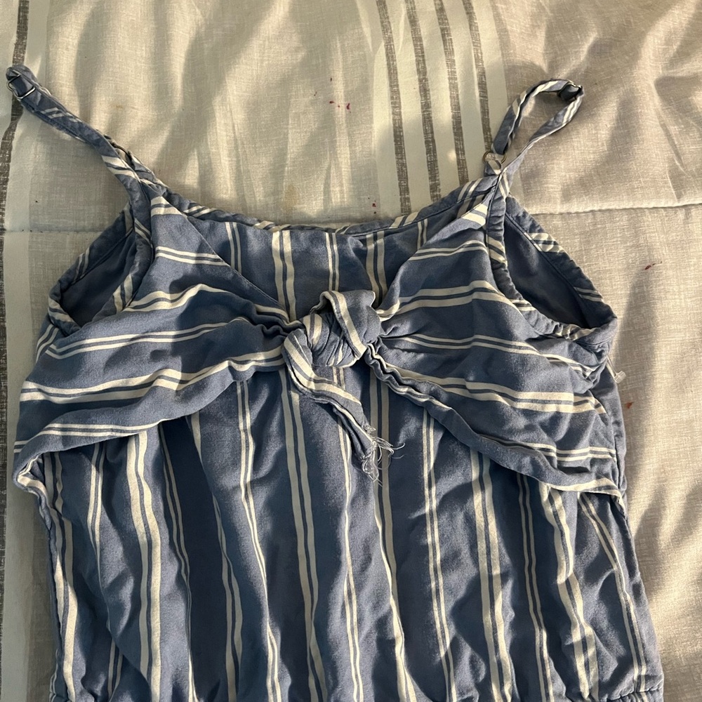 White and baby blue stripe jumpsuit with a bow. Gently worn